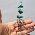 filigree dragon suncatcher in hand